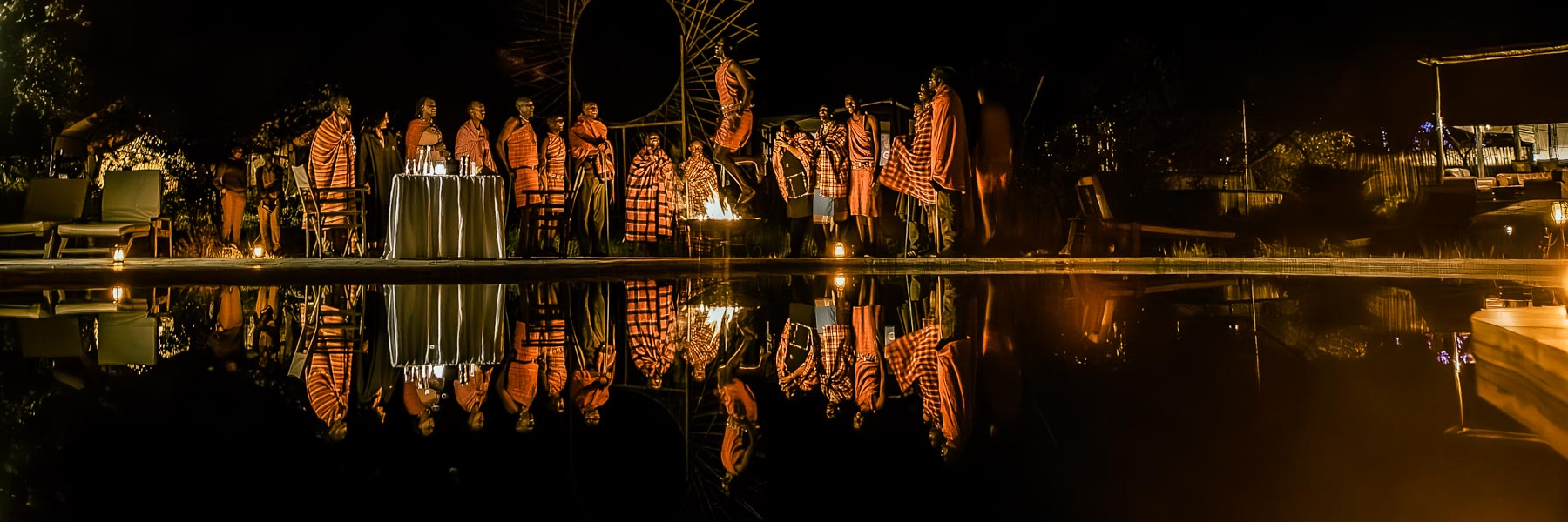 Masai warriors reflected in the pool at night — Ilora Retreats, Masai Mara